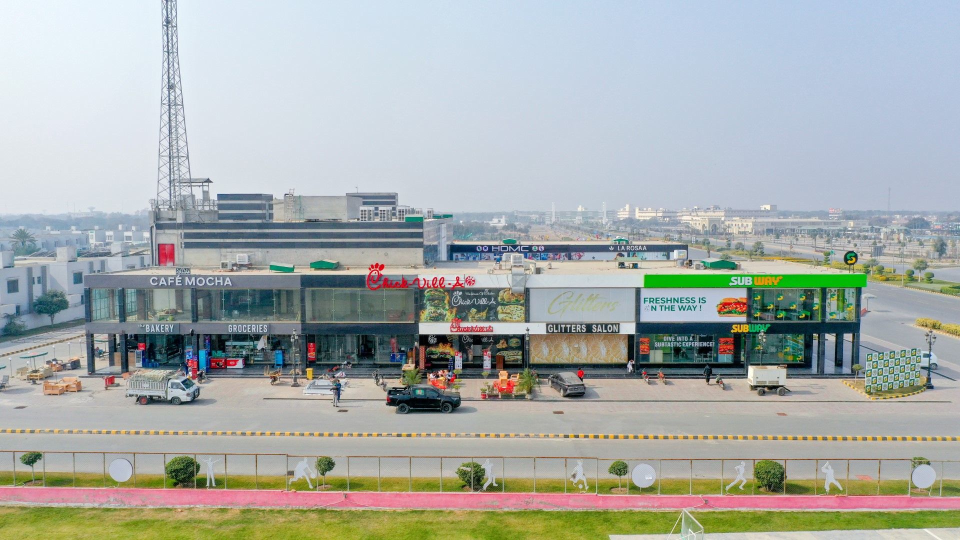 Commercial site in DHA Multan, featuring modern buildings, wide roads, and well-planned infrastructure in a vibrant urban setting.